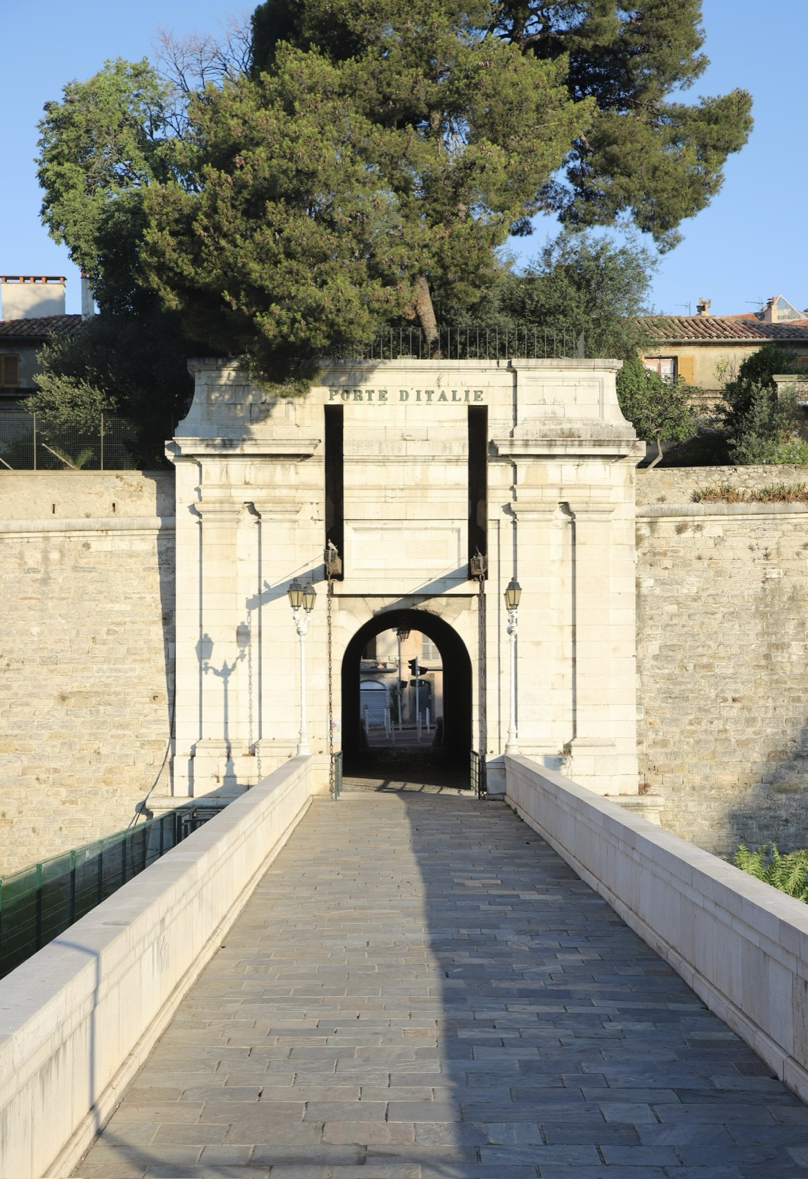 The stone Porte d'Italie gateway and its bridge in morning light